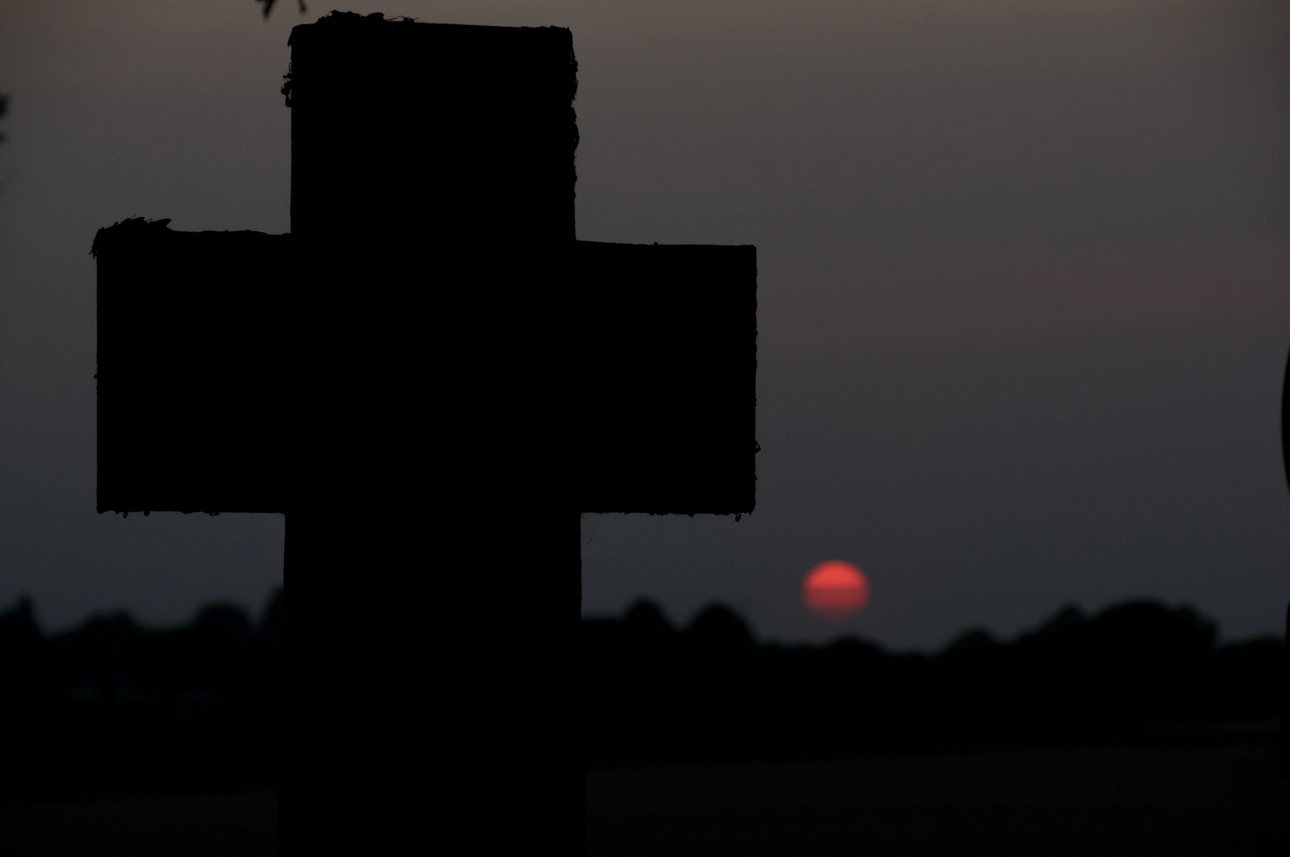 Cross silhouette against the sun (symbolic, no people)
