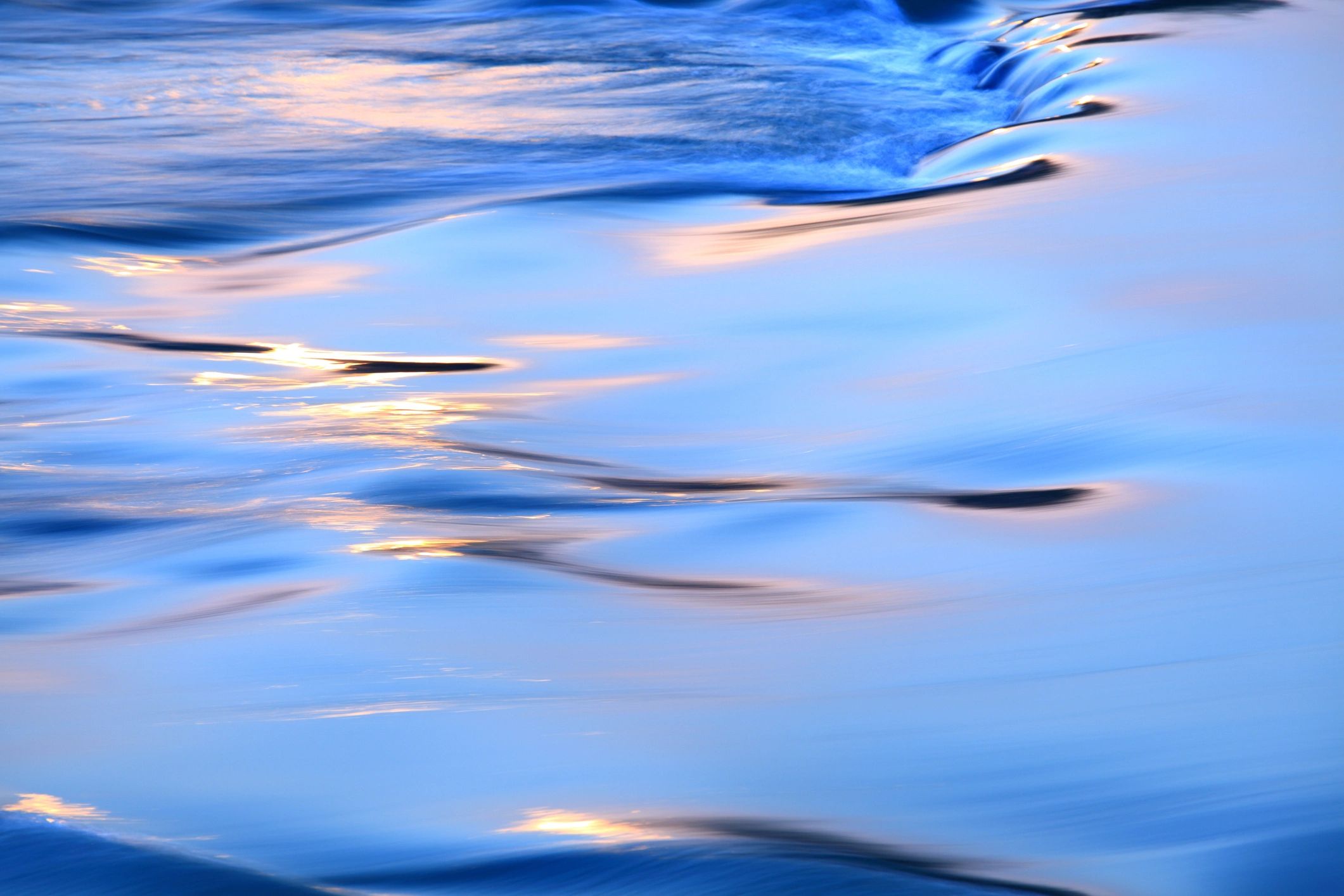 Abstract flowing river water with light reflections